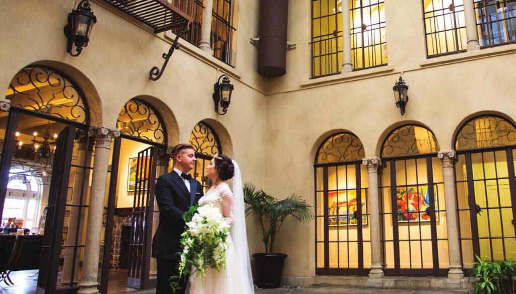 A wedding couple in the courtyard of the Riverside Art Museum, a Bamboo Island Catering partner venue.